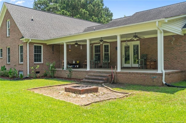 1438 Division Pl, Fayetteville, NC 28312 - rear view of house with a ceiling fan, a lawn, brick siding, and a patio