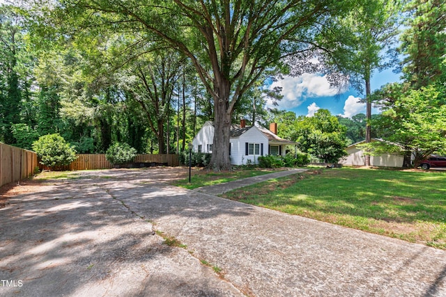 322 Jones Franklin Rd, Raleigh, NC 27606 - view of front facade with a chimney and concrete driveway
