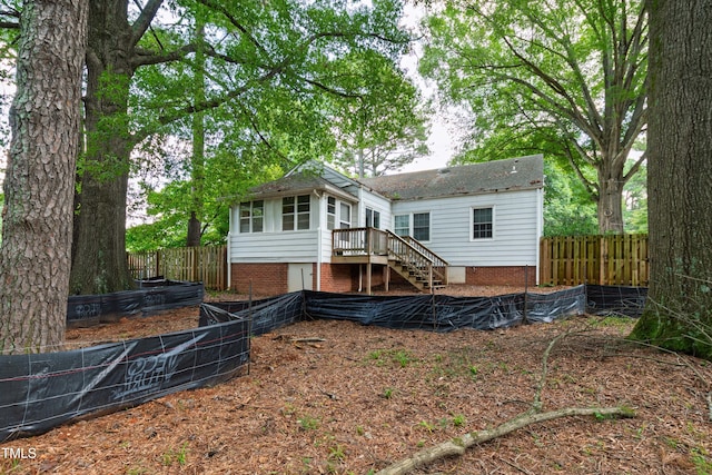 322 Jones Franklin Rd, Raleigh, NC 27606 - rear view of property featuring stairs and a vegetable garden