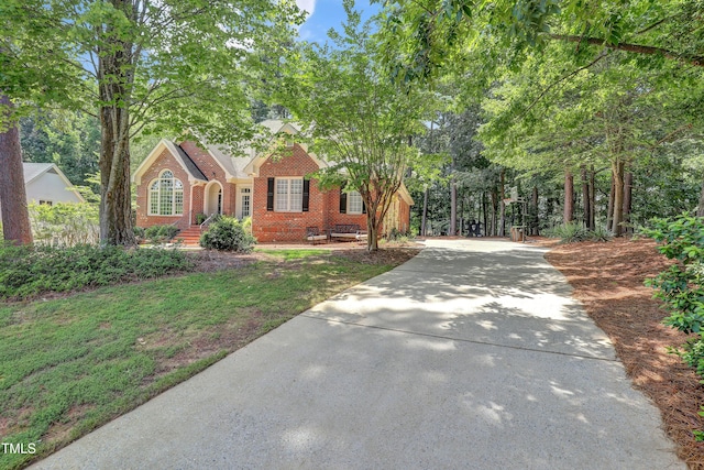 5004 Sunset Forest Cir, Holly Springs, NC 27540 - view of front facade with driveway and brick siding