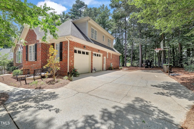 5004 Sunset Forest Cir, Holly Springs, NC 27540 - view of side of home with brick siding, driveway, roof with shingles, and a garage