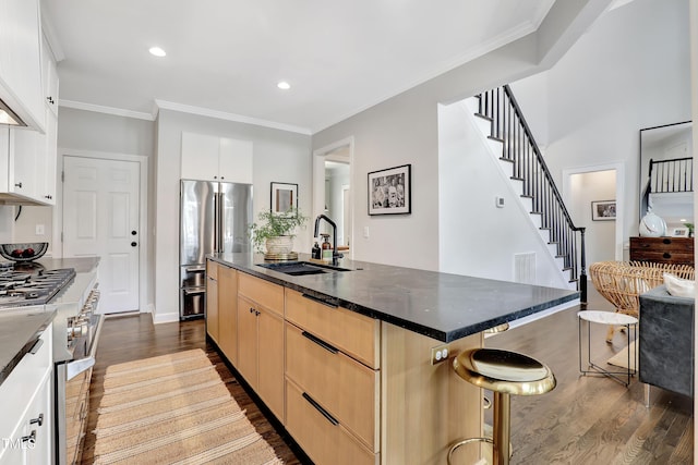 5004 Sunset Forest Cir, Holly Springs, NC 27540 - kitchen featuring appliances with stainless steel finishes, dark wood-style floors, light brown cabinetry, a breakfast bar, and crown molding