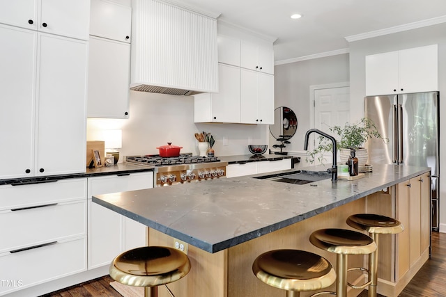 5004 Sunset Forest Cir, Holly Springs, NC 27540 - kitchen with dark wood-style floors, high end fridge, ornamental molding, a kitchen breakfast bar, and premium range hood