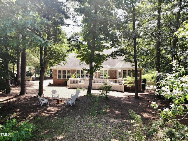 5004 Sunset Forest Cir, Holly Springs, NC 27540 - rear view of property with a deck and brick siding