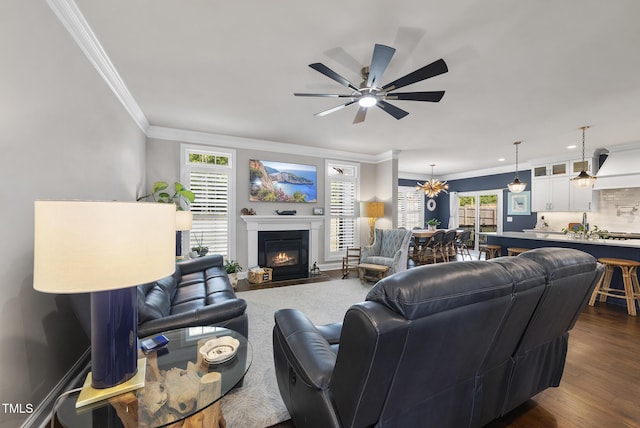 210 Meadow Lake Dr, Youngsville, NC 27596 - living room featuring ornamental molding, a fireplace with flush hearth, ceiling fan, and dark wood-style floors
