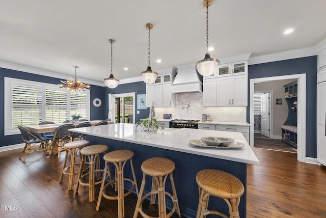 210 Meadow Lake Dr, Youngsville, NC 27596 - kitchen with custom range hood, light countertops, ornamental molding, range with gas cooktop, and tasteful backsplash