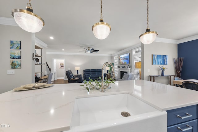 210 Meadow Lake Dr, Youngsville, NC 27596 - kitchen featuring open floor plan, crown molding, blue cabinetry, a ceiling fan, and hanging light fixtures