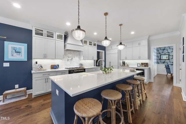 210 Meadow Lake Dr, Youngsville, NC 27596 - kitchen with premium range hood, tasteful backsplash, light countertops, ornamental molding, and an island with sink