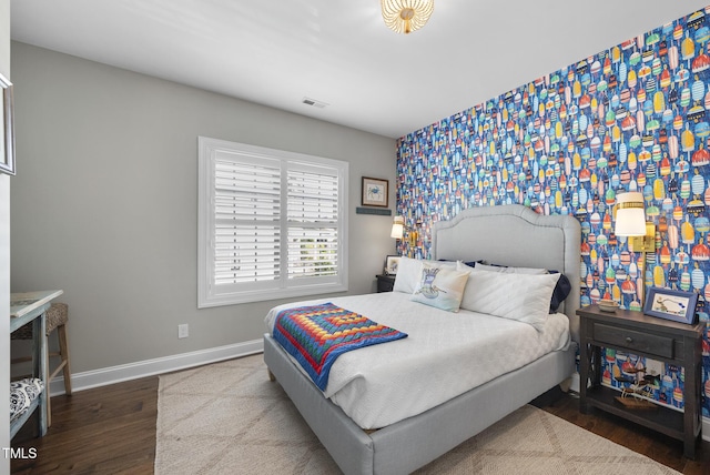 210 Meadow Lake Dr, Youngsville, NC 27596 - bedroom with wood finished floors, wallpapered walls, and an accent wall