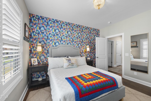 210 Meadow Lake Dr, Youngsville, NC 27596 - bedroom featuring wallpapered walls, an accent wall, and wood finished floors