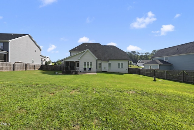210 Meadow Lake Dr, Youngsville, NC 27596 - back of property featuring a sunroom, a fenced backyard, a patio area, and roof with shingles