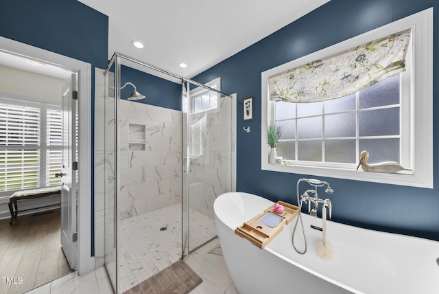 210 Meadow Lake Dr, Youngsville, NC 27596 - bathroom with a freestanding tub, a marble finish shower, recessed lighting, and marble look tile flooring