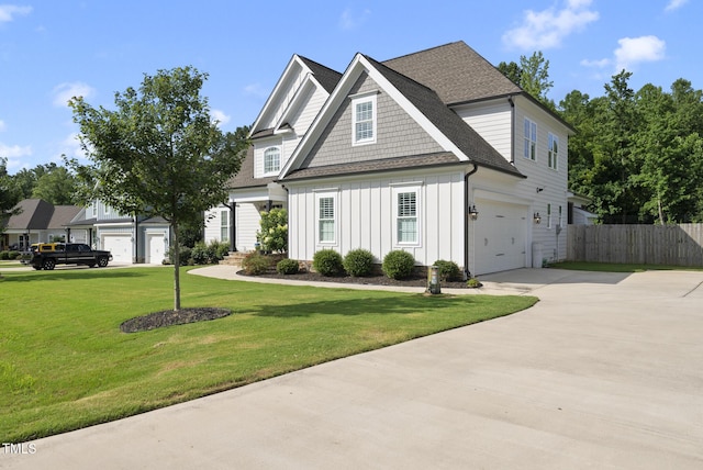 210 Meadow Lake Dr, Youngsville, NC 27596 - view of front of home featuring board and batten siding, driveway, a shingled roof, and an attached garage