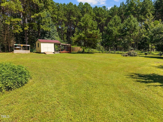 270 Ballard Pruitt Rd, Franklinton, NC 27525 - view of grassy yard featuring a storage unit and a wooded view