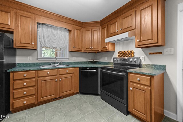 270 Ballard Pruitt Rd, Franklinton, NC 27525 - kitchen with black appliances, under cabinet range hood, dark countertops, brown cabinetry, and light tile patterned floors