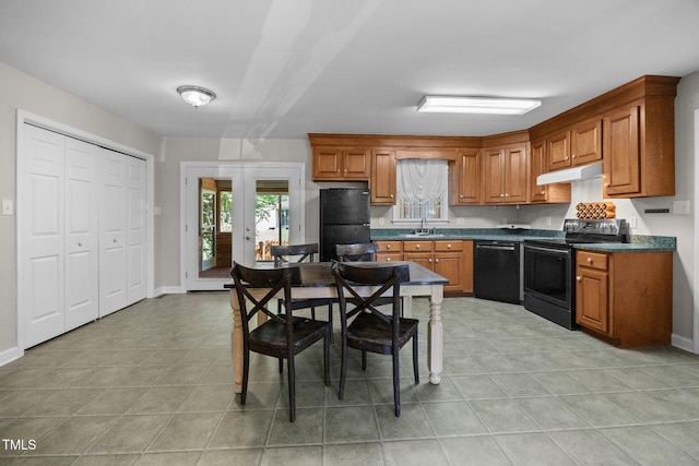 270 Ballard Pruitt Rd, Franklinton, NC 27525 - kitchen with black appliances, dark countertops, brown cabinetry, and under cabinet range hood