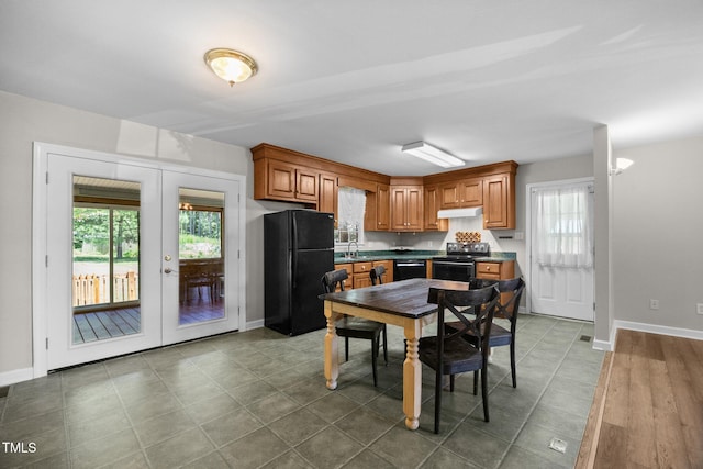 270 Ballard Pruitt Rd, Franklinton, NC 27525 - kitchen featuring black appliances, healthy amount of natural light, and brown cabinetry