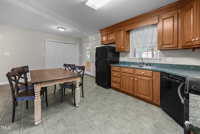 270 Ballard Pruitt Rd, Franklinton, NC 27525 - kitchen featuring black appliances, brown cabinetry, dark countertops, and healthy amount of natural light