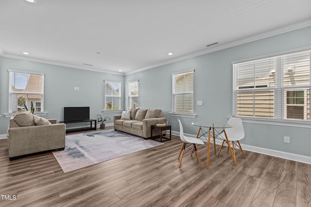 113 Canary Ct, Raleigh, NC 27610 - living room with wood finished floors, ornamental molding, recessed lighting, and plenty of natural light