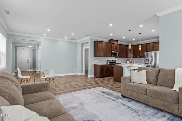 113 Canary Ct, Raleigh, NC 27610 - living area featuring light wood finished floors, recessed lighting, and crown molding