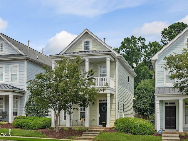 7712 Acc Blvd, Raleigh, NC 27617 - view of front of property featuring a standing seam roof, a balcony, a porch, and a metal roof
