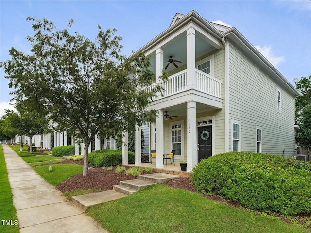 7712 Acc Blvd, Raleigh, NC 27617 - neoclassical home with ceiling fan, a balcony, covered porch, and a front yard