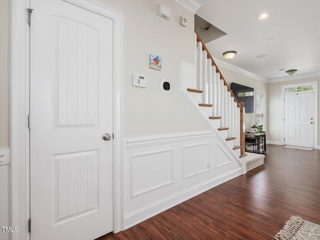 7712 Acc Blvd, Raleigh, NC 27617 - stairway with crown molding, wood finished floors, and wainscoting