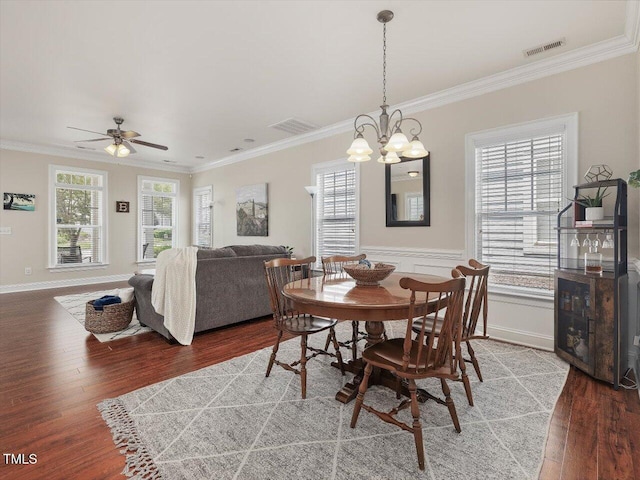 7712 Acc Blvd, Raleigh, NC 27617 - dining room featuring wood finished floors, crown molding, a chandelier, and ceiling fan