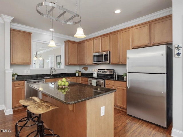 7712 Acc Blvd, Raleigh, NC 27617 - kitchen featuring appliances with stainless steel finishes, dark wood finished floors, crown molding, a center island, and pendant lighting