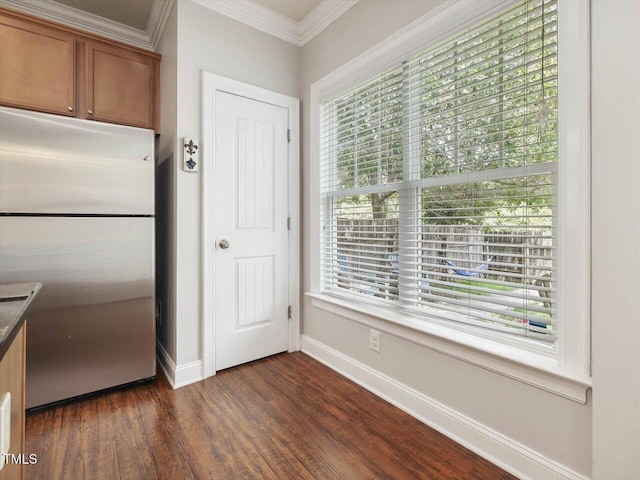 7712 Acc Blvd, Raleigh, NC 27617 - kitchen featuring freestanding refrigerator, brown cabinets, crown molding, dark wood finished floors, and dark countertops