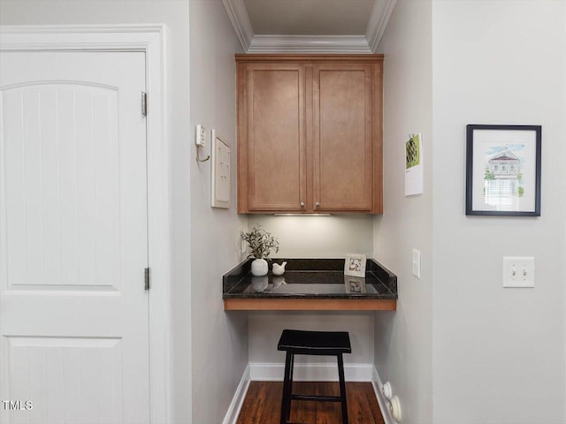 7712 Acc Blvd, Raleigh, NC 27617 - bar with crown molding, built in desk, and dark wood-style floors