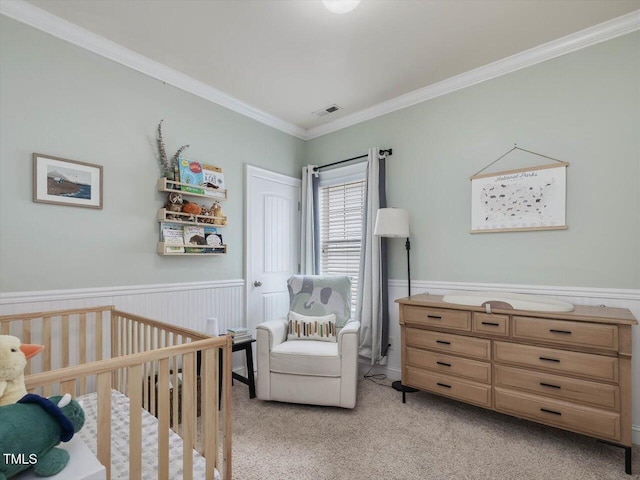 7712 Acc Blvd, Raleigh, NC 27617 - bedroom featuring ornamental molding, light colored carpet, a nursery area, and wainscoting