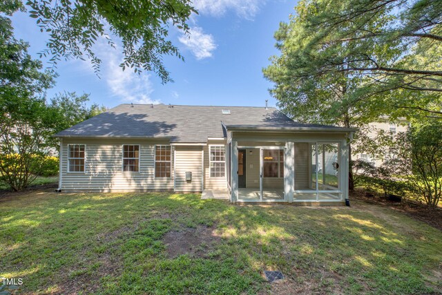 2304 Folger St, Raleigh, NC 27604 - back of house with a sunroom, a lawn, and a shingled roof