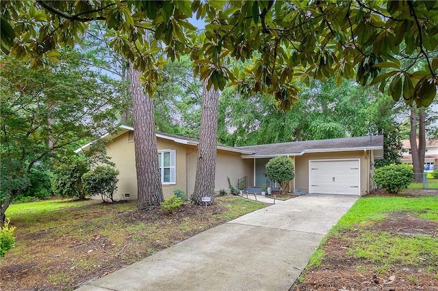 1828 Notre Dame Pl, Fayetteville, NC 28304 - view of front of property featuring stucco siding, a garage, and driveway