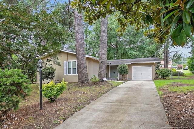1828 Notre Dame Pl, Fayetteville, NC 28304 - view of front of property featuring a garage, concrete driveway, stucco siding, and crawl space