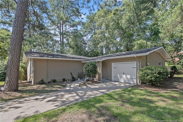 1828 Notre Dame Pl, Fayetteville, NC 28304 - view of front of home featuring a garage, asphalt driveway, and stucco siding