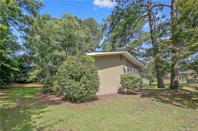 1828 Notre Dame Pl, Fayetteville, NC 28304 - view of home's exterior with a lawn and stucco siding