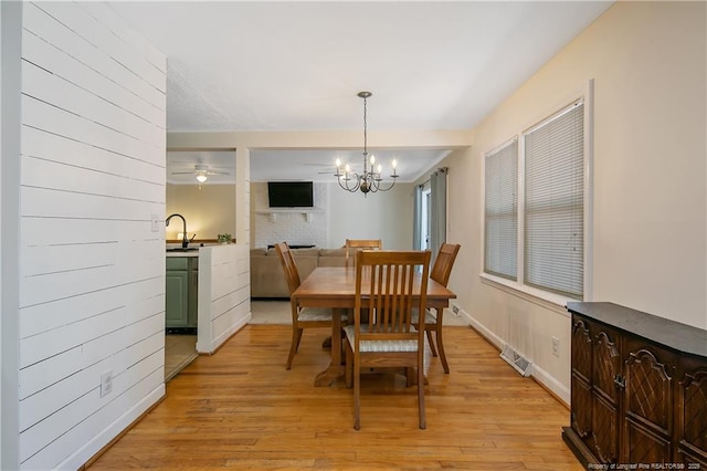 1828 Notre Dame Pl, Fayetteville, NC 28304 - dining area with light wood-type flooring and a chandelier