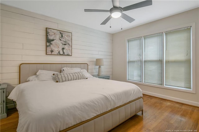 1828 Notre Dame Pl, Fayetteville, NC 28304 - bedroom with wood finished floors, wood walls, and ceiling fan