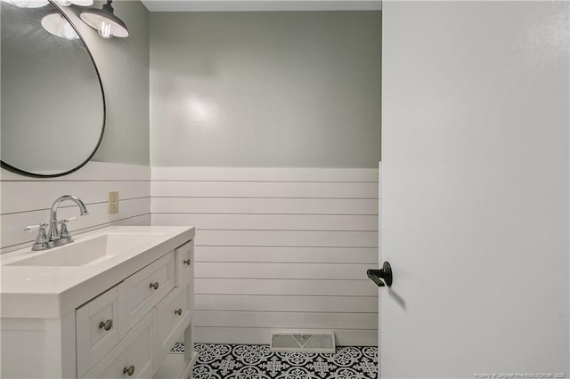1828 Notre Dame Pl, Fayetteville, NC 28304 - bathroom featuring vanity, wainscoting, and tile patterned flooring