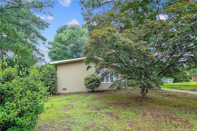 1828 Notre Dame Pl, Fayetteville, NC 28304 - view of property exterior with crawl space, stucco siding, and a lawn