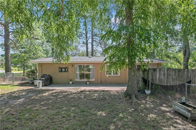 1828 Notre Dame Pl, Fayetteville, NC 28304 - rear view of house featuring stucco siding and a patio