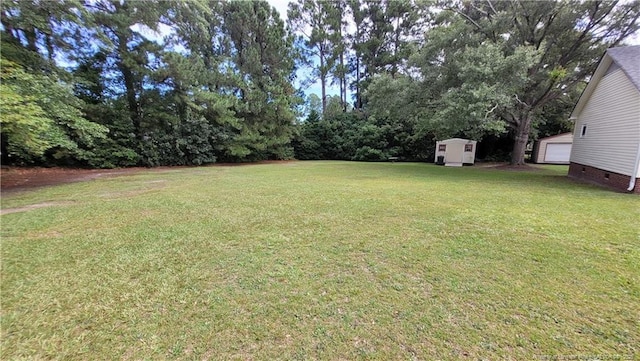 2508 N Roberts Ave N, Lumberton, NC 28358 - view of grassy yard with a storage unit and a detached garage