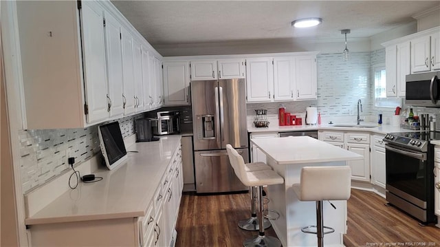 2508 N Roberts Ave N, Lumberton, NC 28358 - kitchen with appliances with stainless steel finishes, white cabinetry, light countertops, decorative backsplash, and crown molding