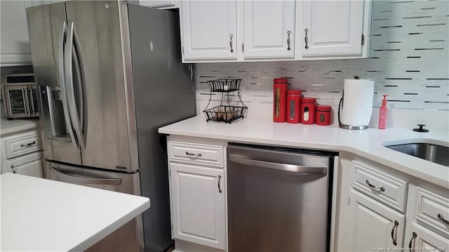 2508 N Roberts Ave N, Lumberton, NC 28358 - kitchen with appliances with stainless steel finishes, white cabinets, light countertops, and tasteful backsplash