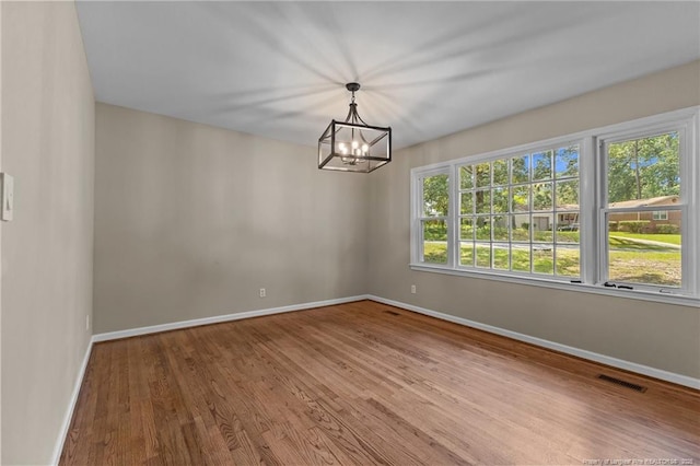 521 Fawn Ct, Fayetteville, NC 28303 - spare room featuring wood finished floors and a chandelier