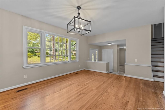 521 Fawn Ct, Fayetteville, NC 28303 - unfurnished dining area with stairway, a chandelier, and wood finished floors