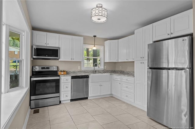 521 Fawn Ct, Fayetteville, NC 28303 - kitchen featuring stainless steel appliances, white cabinetry, and healthy amount of natural light