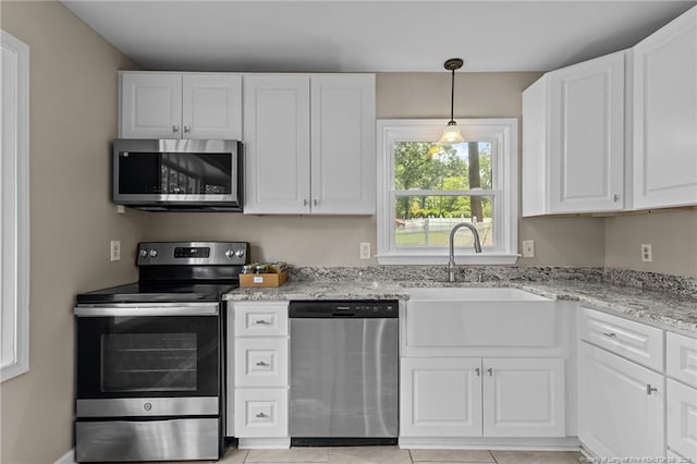 521 Fawn Ct, Fayetteville, NC 28303 - kitchen with stainless steel appliances, white cabinets, light stone countertops, and light tile patterned floors