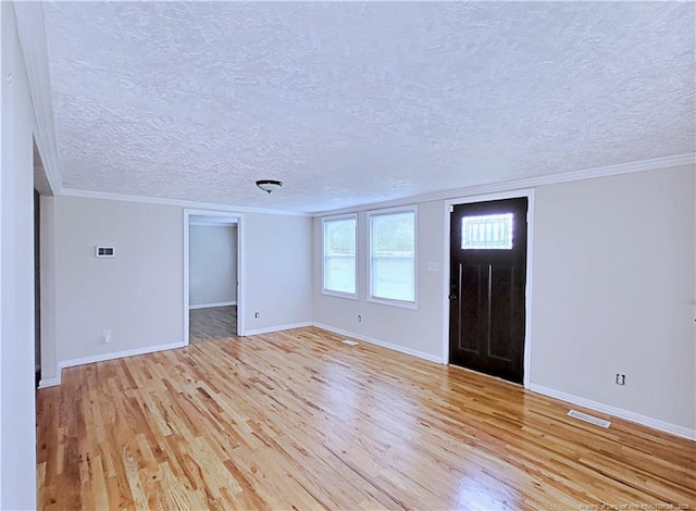 7246 Faircloth Bridge Rd, Stedman, NC 28391 - foyer featuring light wood finished floors, ornamental molding, and a textured ceiling
